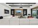 Bright living room with a linear fireplace, accent wall, modern ceiling beams, and a large white sectional at 15104 Blue Bay Ter, Lakewood Ranch, FL 34211