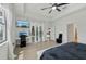 Comfortable main bedroom with desk area, lanai access, ceiling fan, and wood-look flooring at 15104 Blue Bay Ter, Lakewood Ranch, FL 34211