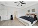 Spacious main bedroom features neutral walls, wood-look floors, and a king-size bed with storage beneath at 15104 Blue Bay Ter, Lakewood Ranch, FL 34211