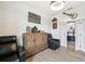 Bright office space with wood-look tile flooring, a media cabinet, and an electric recliner at 15104 Blue Bay Ter, Lakewood Ranch, FL 34211