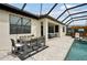 Covered patio with outdoor dining table and poolside bar at 15104 Blue Bay Ter, Lakewood Ranch, FL 34211