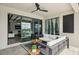 Covered patio features outdoor seating, a ceiling fan, and seamless access to the bright interior of the home at 15104 Blue Bay Ter, Lakewood Ranch, FL 34211