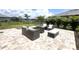 Backyard patio with a cozy outdoor seating area and a modern fire pit for entertaining guests at 15104 Blue Bay Ter, Lakewood Ranch, FL 34211