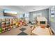 The playroom features colorful shelves, a playhouse, a table and chairs, and two televisions at 15104 Blue Bay Ter, Lakewood Ranch, FL 34211