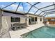 Screened-in pool area offers a dining table, ample lounge space, and a built-in bar for outdoor entertainment at 15104 Blue Bay Ter, Lakewood Ranch, FL 34211