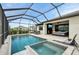 The backyard boasts a pool, hot tub, screened enclosure, patio, and lounge seating at 15104 Blue Bay Ter, Lakewood Ranch, FL 34211