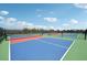 Well-maintained tennis courts with a blue and red surface, providing an excellent space for sports and recreation at 15104 Blue Bay Ter, Lakewood Ranch, FL 34211