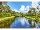 The scenic pond with fountain features palm trees, lush greenery and water reflections at 152 Jose Gaspar Dr # 152, Englewood, FL 34223