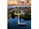 Stunning aerial view of a coastal community with a private pier and gorgeous sunset skies over the water at 1603 Gulf Dr N # 6, Bradenton Beach, FL 34217