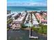 Stunning aerial view of waterfront property with private docks, pool, and beach access on a clear, sunny day at 1603 Gulf Dr N # 6, Bradenton Beach, FL 34217