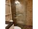 Beautiful bathroom with modern walk-in shower with pebble floor and glass door, complemented by granite countertops at 1603 Gulf Dr N # 6, Bradenton Beach, FL 34217