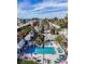 Relaxing community pool with blue lounge chairs and palm trees under a sunny sky, offering a tropical oasis at 1603 Gulf Dr N # 6, Bradenton Beach, FL 34217