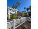 Exterior view of Tradewinds Resort with manicured landscaping, showcasing a charming vacation getaway at 1603 Gulf Dr N # 6, Bradenton Beach, FL 34217