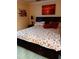 Comfortable bedroom with a decorative floral bedspread, stylish lamps, and artwork creating a serene retreat at 1603 Gulf Dr N # 6, Bradenton Beach, FL 34217