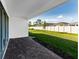 Back patio offers outdoor living space overlooking a well-maintained backyard and white fence at 16097 Old Fox Trl, Port Charlotte, FL 33953