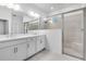 Bright bathroom features a double vanity with a white countertop, a glass-enclosed shower, and modern fixtures at 16097 Old Fox Trl, Port Charlotte, FL 33953