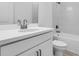 Bathroom featuring a white vanity, white toilet, and tiled tub shower with dark hardware at 16097 Old Fox Trl, Port Charlotte, FL 33953