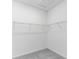 Walk-in closet with wire shelving and gray carpet, providing ample storage space at 16097 Old Fox Trl, Port Charlotte, FL 33953