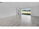 Spacious living room featuring sleek tile flooring and a large sliding glass door to the backyard at 16097 Old Fox Trl, Port Charlotte, FL 33953