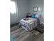 Cozy bedroom features wood-look floors, a comfortable bed, and a soft area rug at 1750 Gold Ave, Sarasota, FL 34235