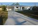 Well maintained front yard with charming single-story home and freshly painted driveway at 1750 Gold Ave, Sarasota, FL 34235