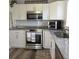 Stylish kitchen with updated appliances, granite countertops, and ample cabinet space at 1750 Gold Ave, Sarasota, FL 34235