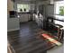 Bright kitchen with stainless steel appliances, white cabinets, and wood grain vinyl flooring at 1750 Gold Ave, Sarasota, FL 34235
