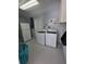 Functional laundry room with a washer, dryer, and additional storage space at 1750 Gold Ave, Sarasota, FL 34235