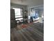 Modern living area featuring a breakfast bar, stainless steel refrigerator, and gray toned flooring at 1750 Gold Ave, Sarasota, FL 34235