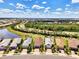 Aerial view of homes with tile roofs, brick driveways, and lush landscaping in a vibrant community setting at 17714 Northwood Pl, Bradenton, FL 34202