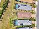 Top-down aerial shot highlighting backyard pools and solar panels in a neighborhood with manicured lawns and landscaping at 17714 Northwood Pl, Bradenton, FL 34202