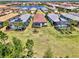 Overhead view of backyard pools and solar panels in a community of modern homes with well-kept lawns and landscaping at 17714 Northwood Pl, Bradenton, FL 34202