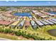 Aerial view of a residential neighborhood with lush landscaping and a picturesque lake at 17714 Northwood Pl, Bradenton, FL 34202