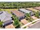 Aerial view of several homes with tile roofs and brick driveways, complemented by lush green landscaping at 17714 Northwood Pl, Bradenton, FL 34202