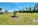 Well-maintained backyard with mature trees, lush lawn, and view of the lake at 17714 Northwood Pl, Bradenton, FL 34202