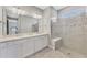 Beautiful bathroom with double vanity, quartz countertop, and glass-enclosed shower with a seat at 17714 Northwood Pl, Bradenton, FL 34202