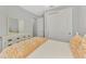 Bedroom featuring neutral walls, sliding closet doors, and a dresser with mirror at 17714 Northwood Pl, Bradenton, FL 34202