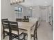 Bright dining room next to an open kitchen space with a large island and modern finishes at 17714 Northwood Pl, Bradenton, FL 34202