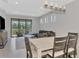 Modern dining area with wooden table, seating, and a view of the outdoor patio at 17714 Northwood Pl, Bradenton, FL 34202
