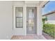 Elegant front door with decorative glass and sidelight, providing natural light and a modern touch at 17714 Northwood Pl, Bradenton, FL 34202