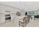 Spacious kitchen with white cabinets, stainless appliances, and large island with seating at 17714 Northwood Pl, Bradenton, FL 34202