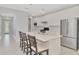 Well-lit kitchen with a large center island, stainless steel refrigerator, and white cabinets at 17714 Northwood Pl, Bradenton, FL 34202