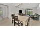 Open-concept living area with dining table, comfortable seating, and sliding glass doors to the screened patio at 17714 Northwood Pl, Bradenton, FL 34202