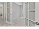 Open-concept office space with light stone floors, neutral walls, and french doors at 17714 Northwood Pl, Bradenton, FL 34202