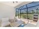A covered brick patio with outdoor furniture, ceiling fan, and view of lush green backyard at 17714 Northwood Pl, Bradenton, FL 34202