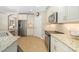 Kitchen featuring stainless steel appliances, granite countertops, and white cabinetry at 182 Bella Vista Ter # 23A, Nokomis, FL 34275
