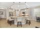 Bright kitchen showcasing an island with granite countertops, stainless steel appliances, and pendant lighting at 182 Bella Vista Ter # 23A, Nokomis, FL 34275