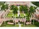 Overhead view of a meticulously landscaped courtyard, featuring statues, lush gardens, and striking architecture at 1829 Cypress Point Ln, Sarasota, FL 34234