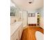 Bright bathroom with a shower, vanity sink, and storage shelving at 1829 Cypress Point Ln, Sarasota, FL 34234