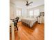 Bright bedroom featuring hardwood floors, a ceiling fan, and multiple windows with shutters at 1829 Cypress Point Ln, Sarasota, FL 34234